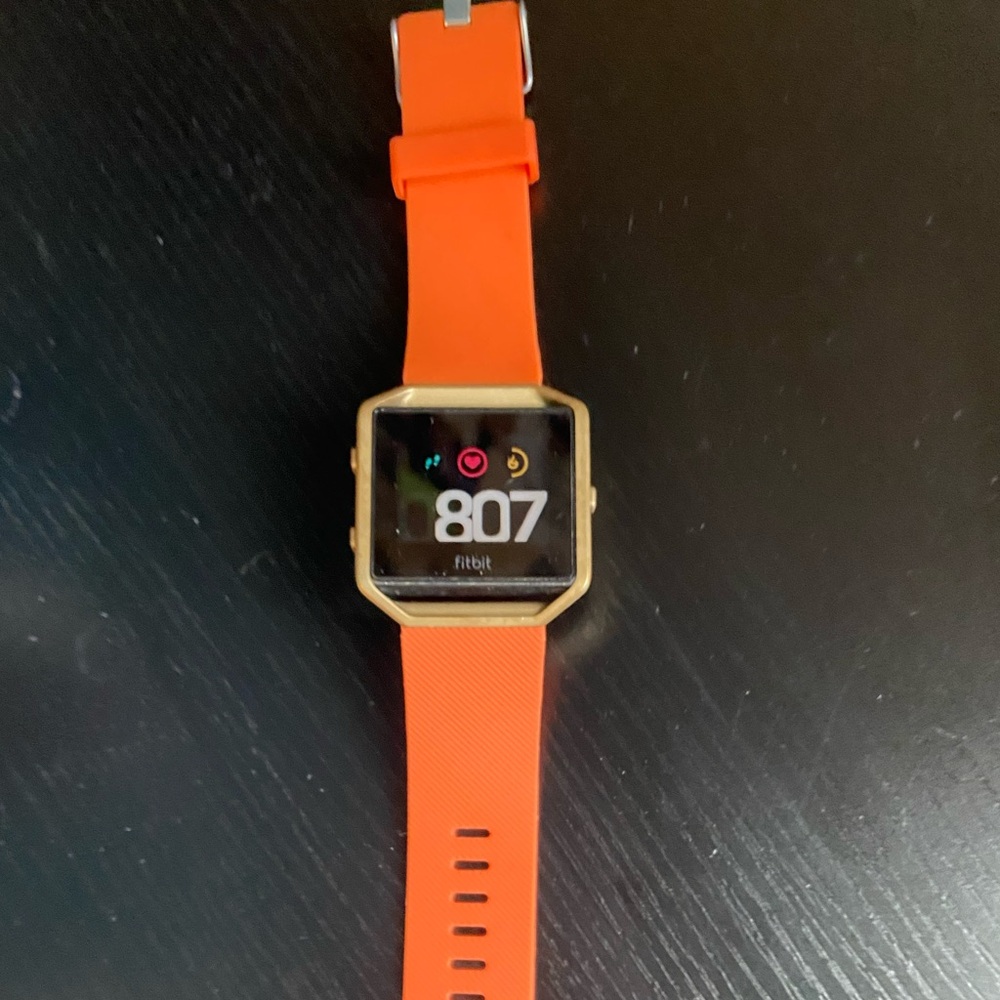 Fitbit Smartwatch with Orange Band and Gold Case